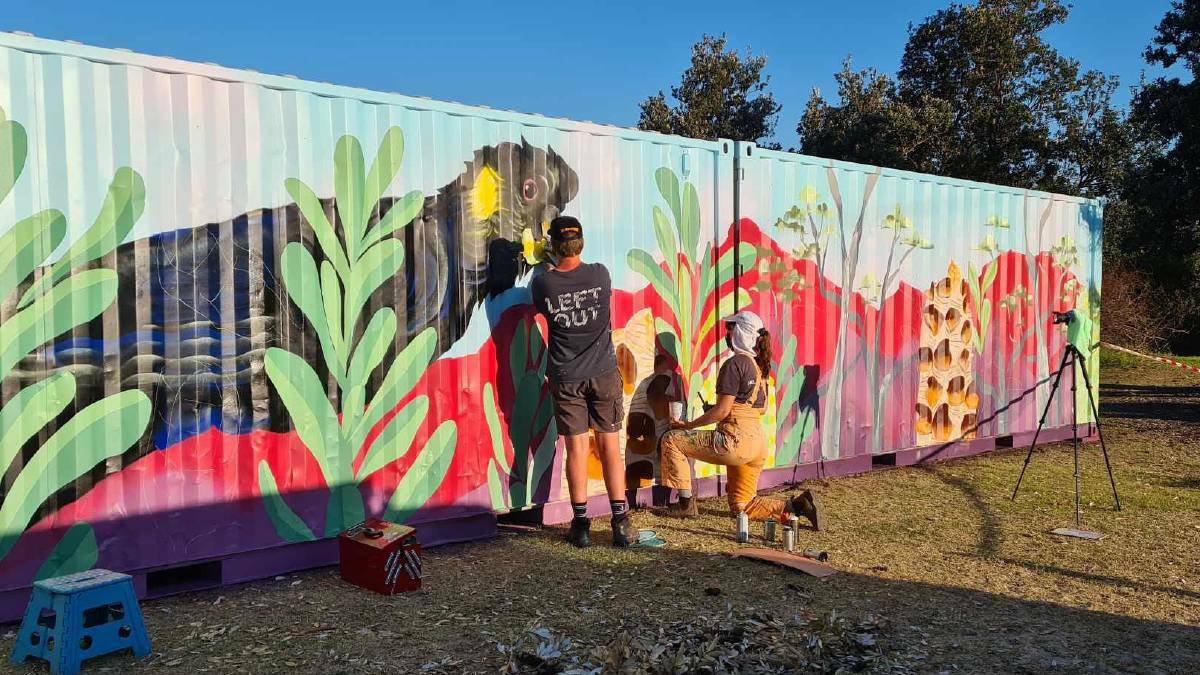 Field of containment: Artist David Cragg paints a mural across the three shipping containers placed along the Botany Bay foreshore where a number of trees were vandalised.