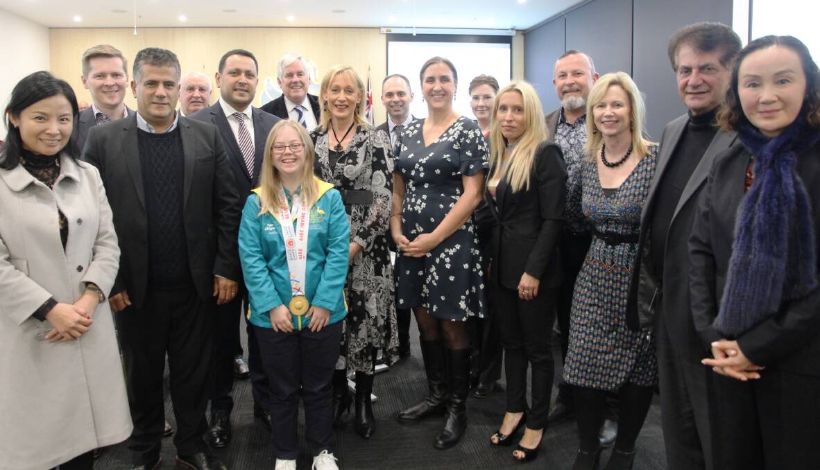 Congratulations: Ellen Maher, centre, is officially congratulated by Georges River councillors this week for her gold medal achievements at the Special Olympics World Summer Games.
