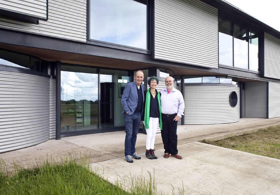 Grand Designs host Kevin McCloud with Colin MacKinnon and Marta Briongos outside their aluminium-clad home.