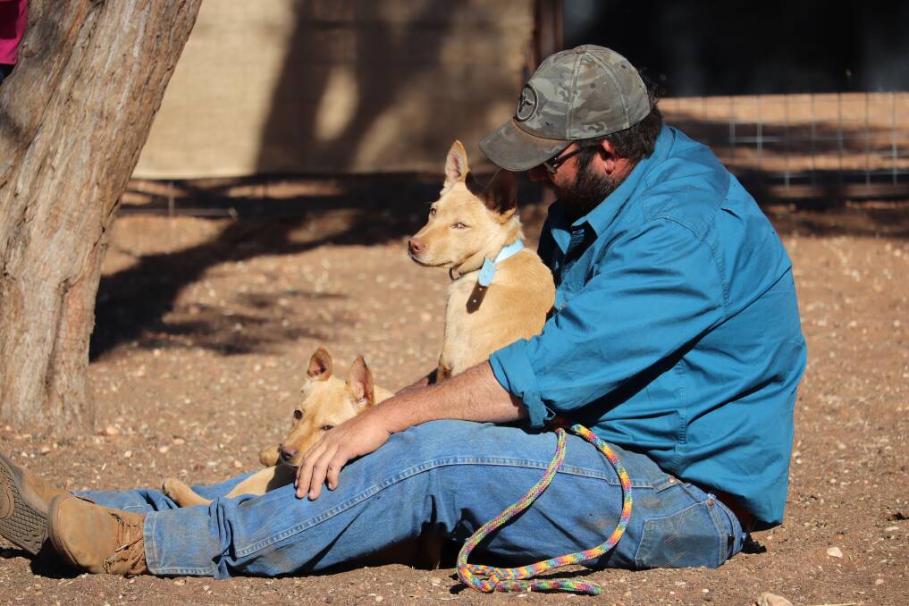 A Kaden Working Dog School participant spending time with his canine mates.