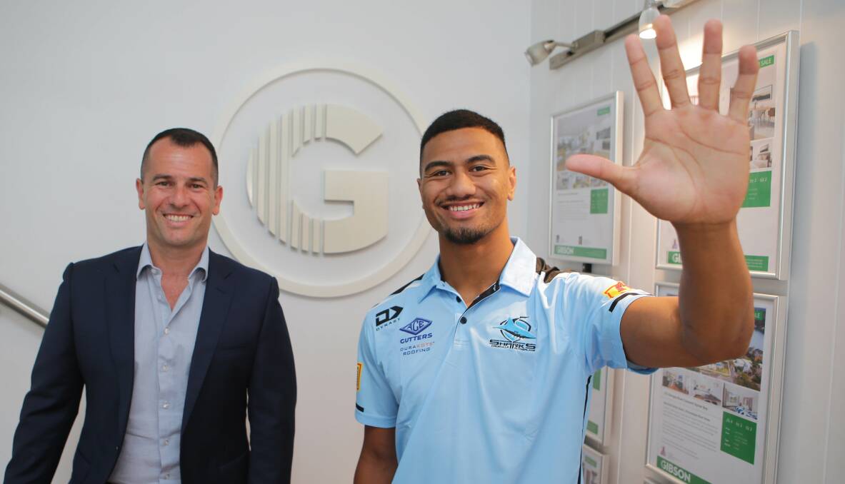 High five:Gibson Partners Ivan Lampret helped out with Ronaldo Mulitalo's fundraising drive for charity Stepping Stone House.Picture John Veage