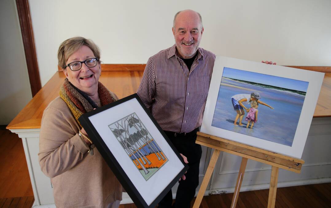 Parliament: St George Art Society Co-ordinator Wren Craw and President Jim West display two pieces that are currently on show at NSW Parliament House.Picture John Veage