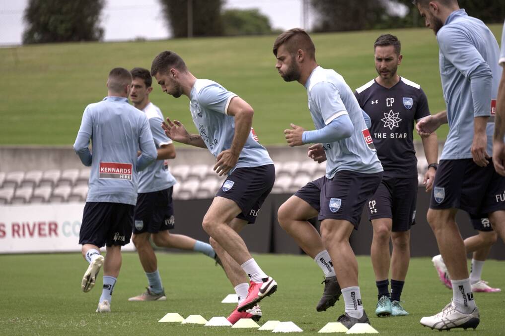 Ready:The Sydney FC squad is put through its paces at Jubilee Stadium on Wednesday