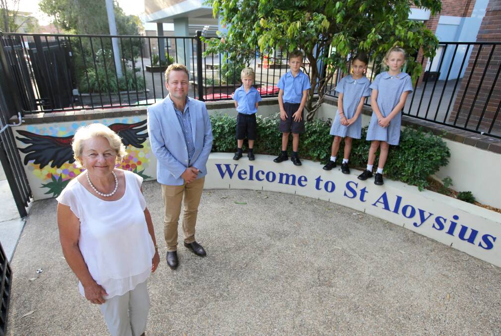Centenary: St Aloysius Cronulla is turning 100 this year. Pictured are three generations of the Coady family including Ben with his mother Carol and children Edward, 5, Flynn, 8, Tamara, 9, and Keira, 11. Picture John Veage
