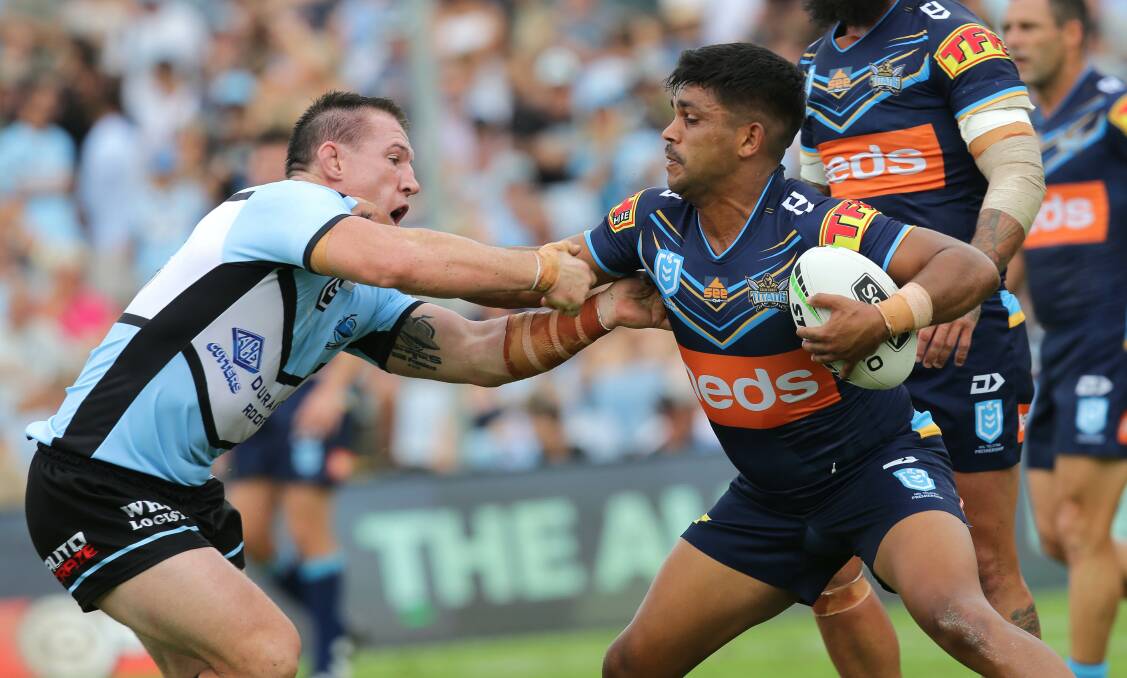 Favourites: Sharks skipper Paul Gallen comes to grips with Titans and former Cronulla junior star Tyrone Peachey in their first encounter this season.Picture John Veage