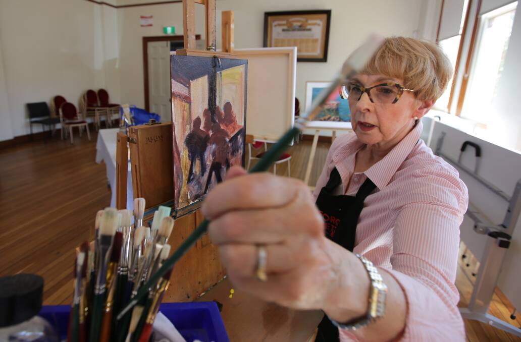 On show: The current President of the St George Art Society Jean Harrow puts the finishing touches to a display piece. Picture: John Veage 