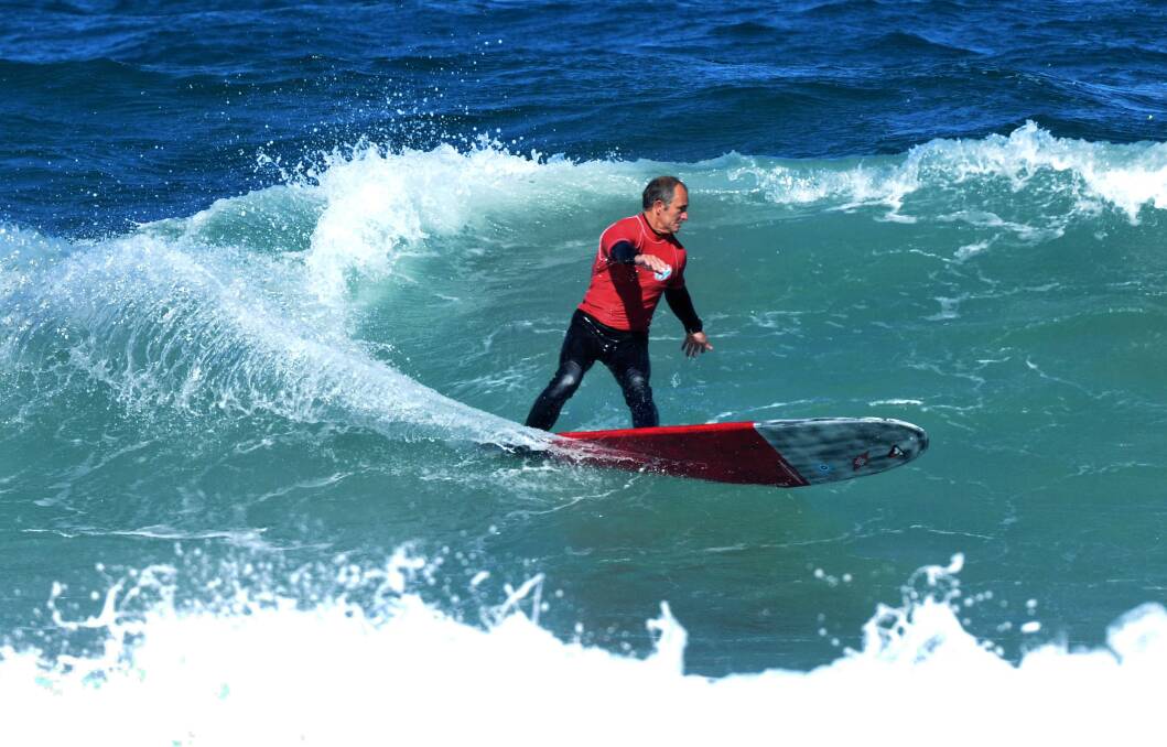 Hard work: North side surfer Jason Livingston took the open and masters titles at this year's Southside Malibu Club Spring Classic held in big waves at North Cronulla Beach. Picture: Ray Wilkinson
