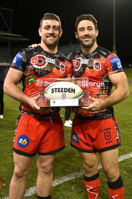Celebration: Andrew McCullough became only the 44th player to join the 300 game exclusive Club, presented with the game ball.Picture NRL Images 
