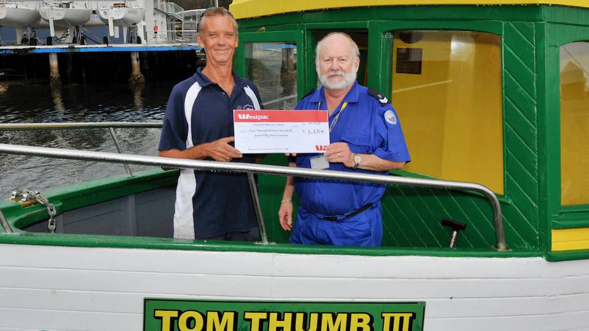 Presentation:Carl Rogan (left) presented Marine Rescue's Lewis Stockbridge with a donation from the event