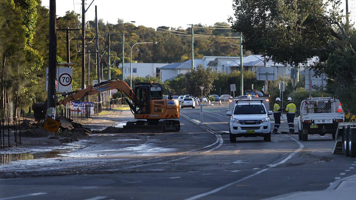Damage: Workers cleaning up after a burst water main on Captain Cook drive.Picture John Veage