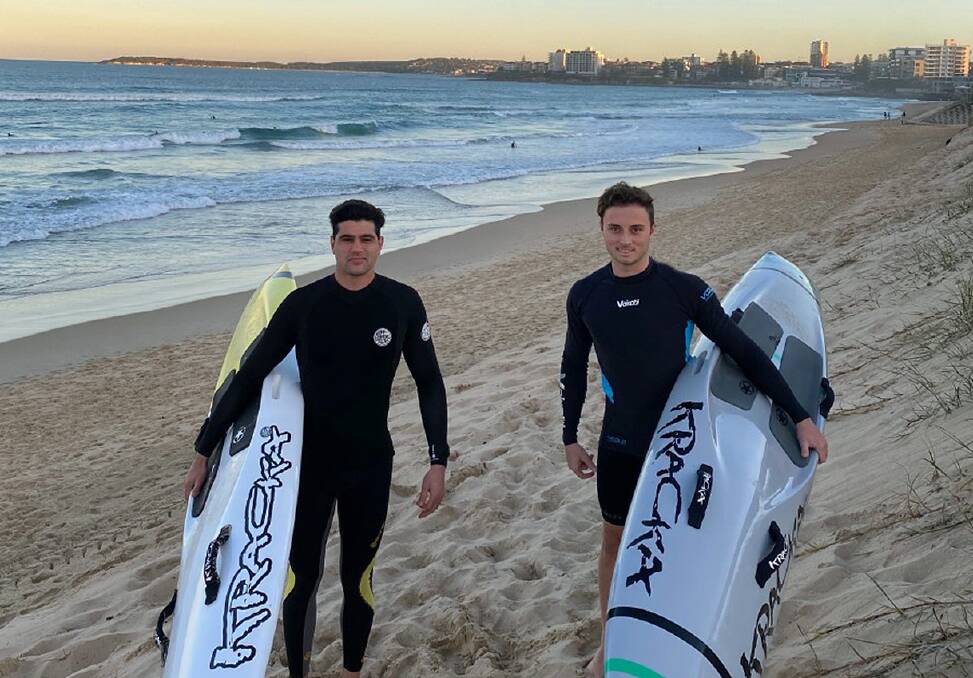 Hard work: Elouera SLSC board paddlers Nathan Neale and Andrew Sharp on the beach after training this week.