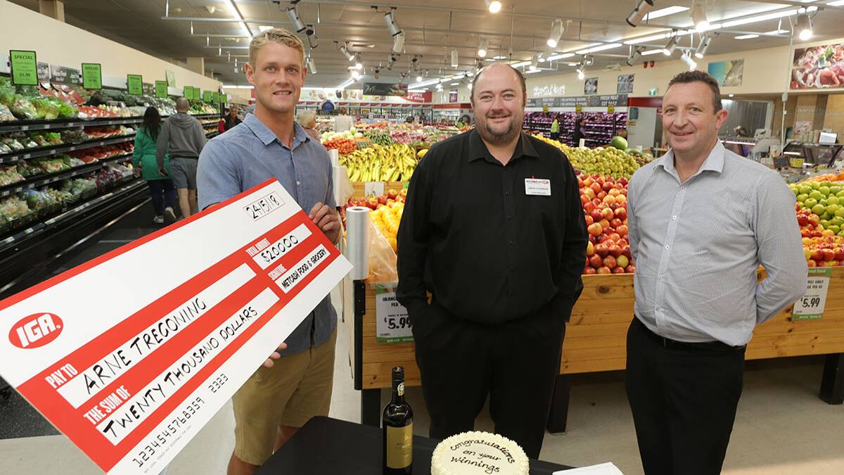 Winner: IGA shopper Arne Tregoning is presented with his "cheque" by store manager Simon Fackender (centre) and retail operations manager NSW Ash Thompson.