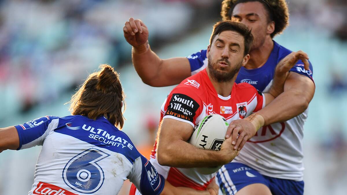 Ben Hunt of the Dragons is tackled by Raymond Faitala and Kieran Foran of the Bulldogs during the Round 13 NRL match at ANZ Stadium .Picture AAP Image/Dean Lewins