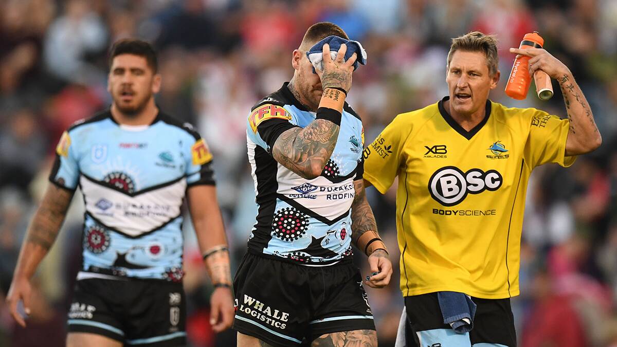 Josh Dugan of the Sharks is taken off after colliding with Tyson Frizell of the Dragons during the Round 11 NRL match Picture AAP Image/Dean Lewins