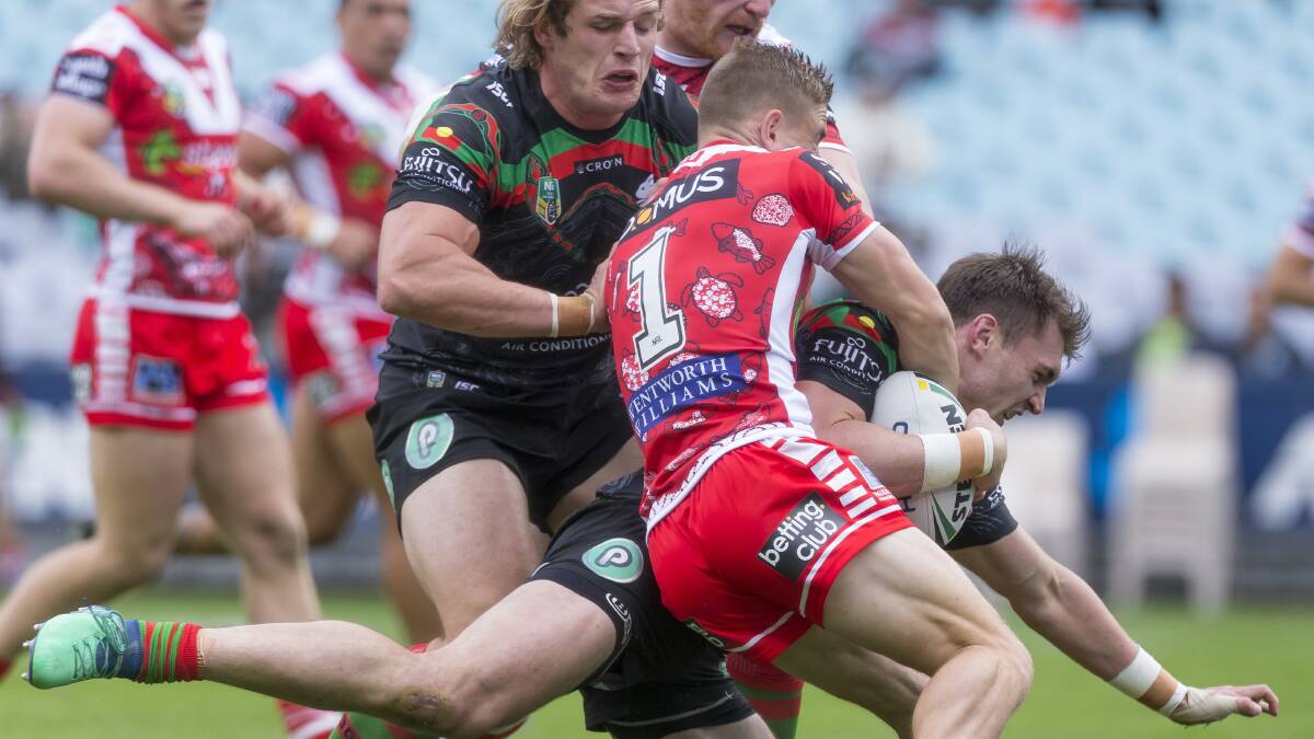 Crashing over: South Sydney back-rower Angus Crichton holds off Dragons fullback Matt Dufty to score. Picture: AAP Images