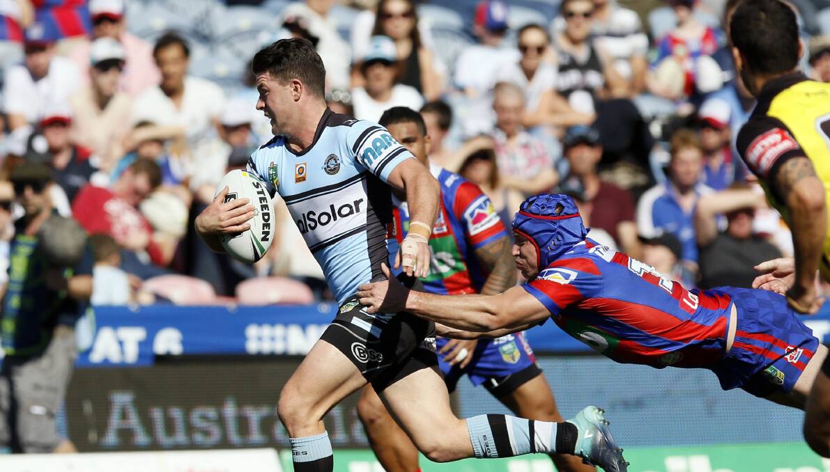 Try time: Sharks halfback Chad Townsend gets around Knights forward Jamie Buhrer to score on Sunday. Picture: AAP Image