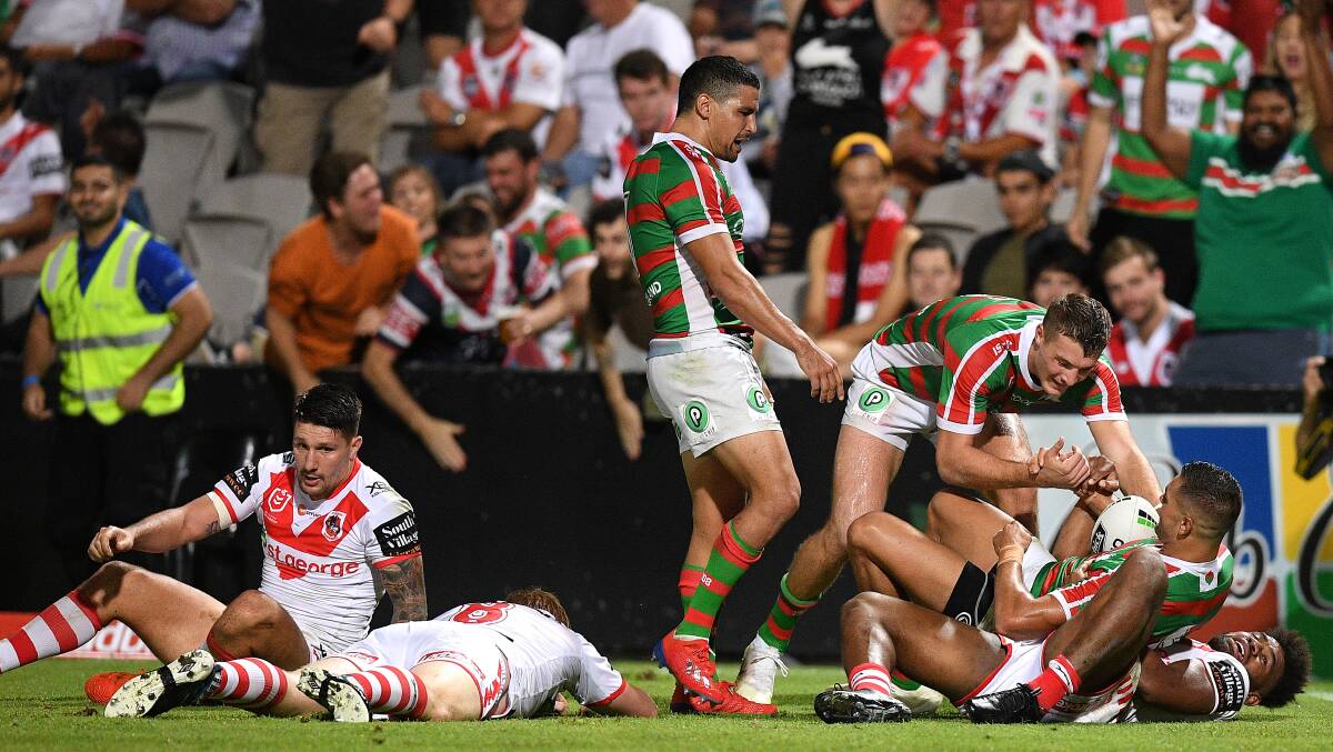 Unstoppable: Braidon Burns celebrates his try for South Sydney against the Dragons on Thursday night. Picture: Dan Himbrechts/AAP Image
