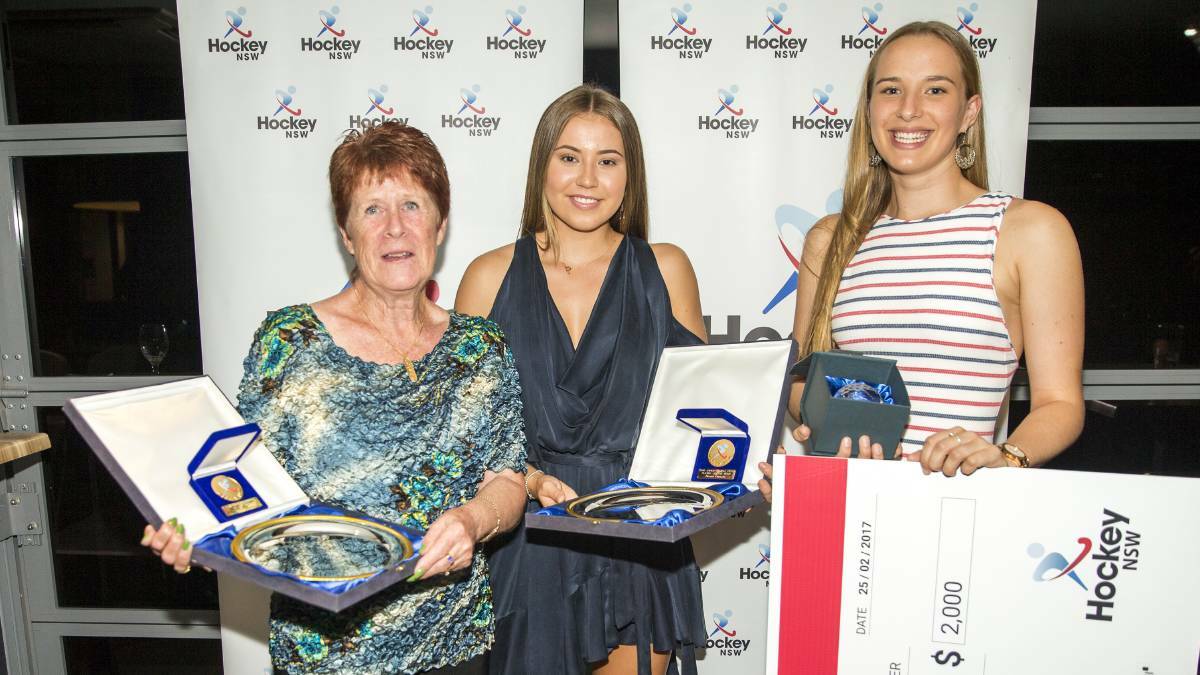 Mrs Harriss (left) receiving her women's Masters NSW player of the year award in 2016. Picture: Hockey NSW