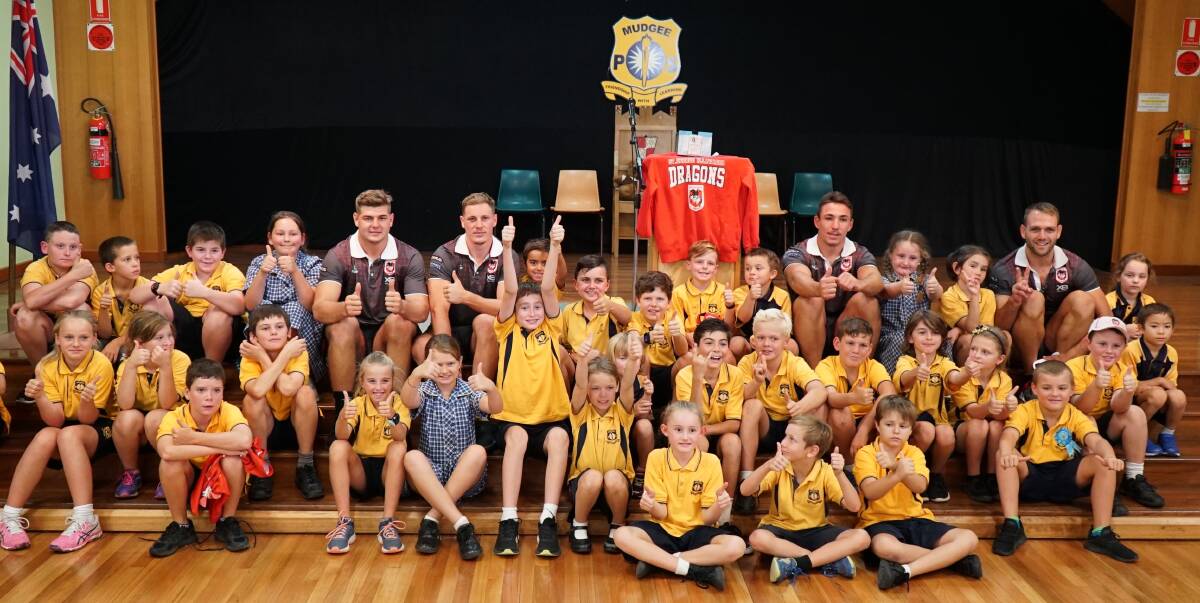 Right at home: Dragons players Jason Nightingale, Kurt Mann, Reece Robson and Blake Lawrie meet Mudgee Public School students during a community visit in February.