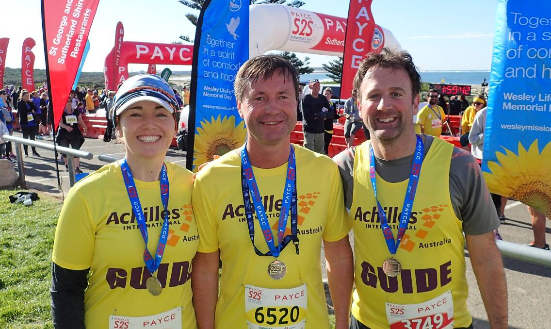 Guiding lights: Brett Anthony with Achilles Sydney guides Eliza Middleton and Stewart Moore at the 2017 Sutherland 2 Surf. Picture: Supplied