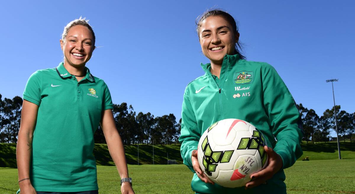 Green and gold girls: St George footballer Teresa Polias (right) with Kyah Simon ahead of the 2015 World Cup. Picture: Brendan Esposito