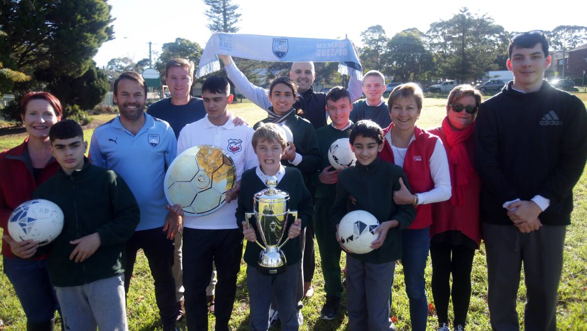 All smiles: Sydney FC community football officer Paul Reid with staff and students from Minerva School, Sutherland. Picture: Chris Lane