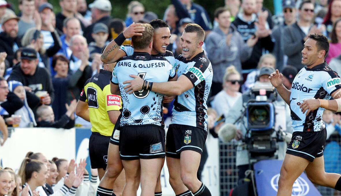 Electric: Sharks players congratulate Valentine Holmes after the winger's first half try against Canterbury. Picture: Chris Lane