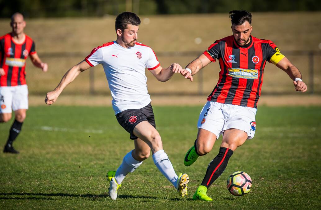 On the ball: Rockdale City captain Daniel Petkovski keeps the ball away from a Wollongong player during the Suns' 2-1 win on Sunday. Picture: Football NSW