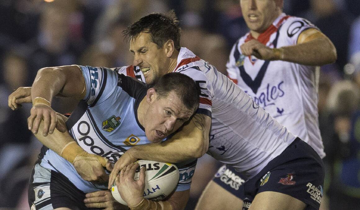 Not coming: Mitchell Pearce makes a tackle on Sharks captain Paul Gallen last season. Picture: Craig Golding/AAP Image