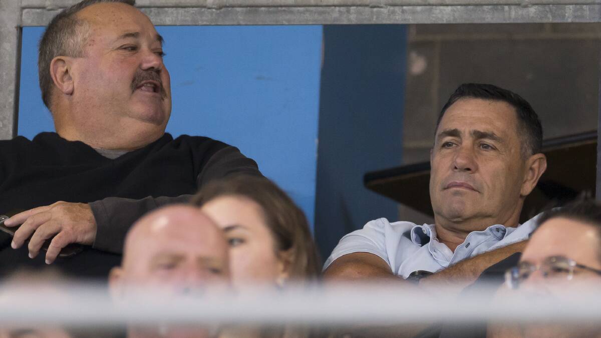 Watching: Former Sharks coach Shane Flanagan (right) watches Cronulla's trial with Manly alongside Darryl Brohman. Picture: Craig Golding/AAP Image