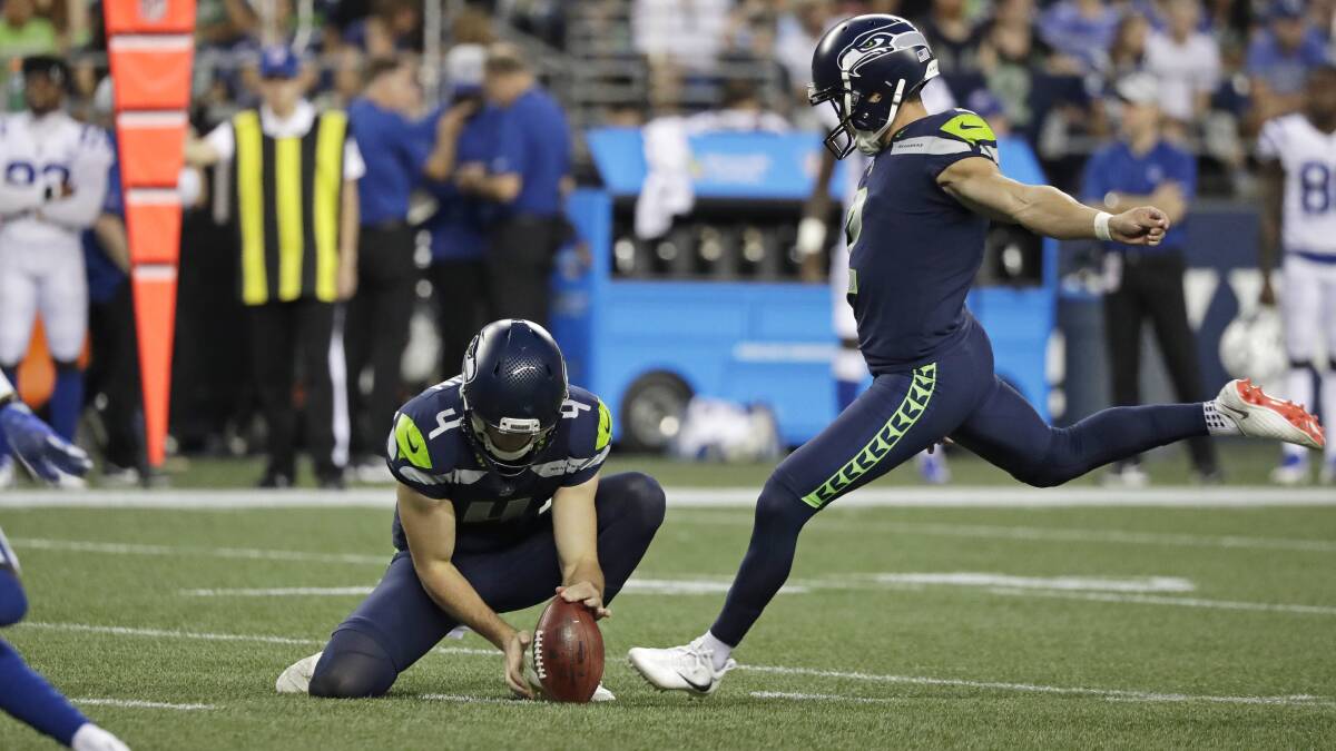 Michael Dickson holds the ball for Seattle teammate Jason Myers who kicks a field goal in pre-season. Picture: AP Photo