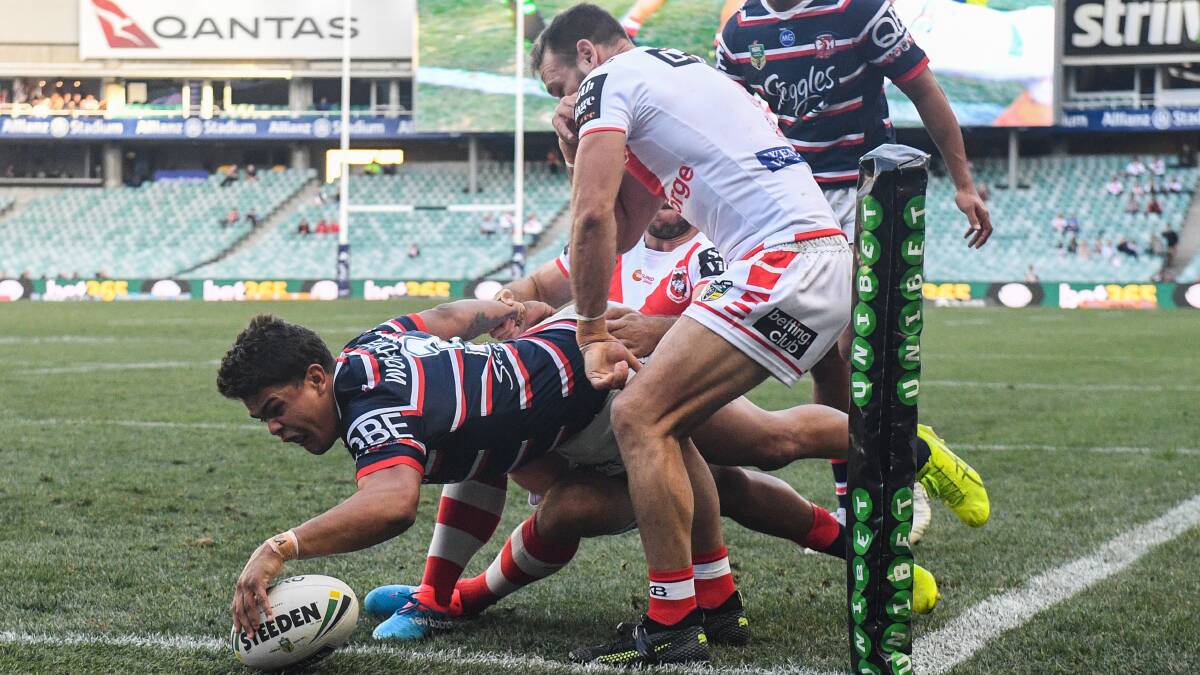 Unstoppable: Latrell Mitchell scored three tries for the Roosters against the Dragons on Sunday. Picture: AAP
