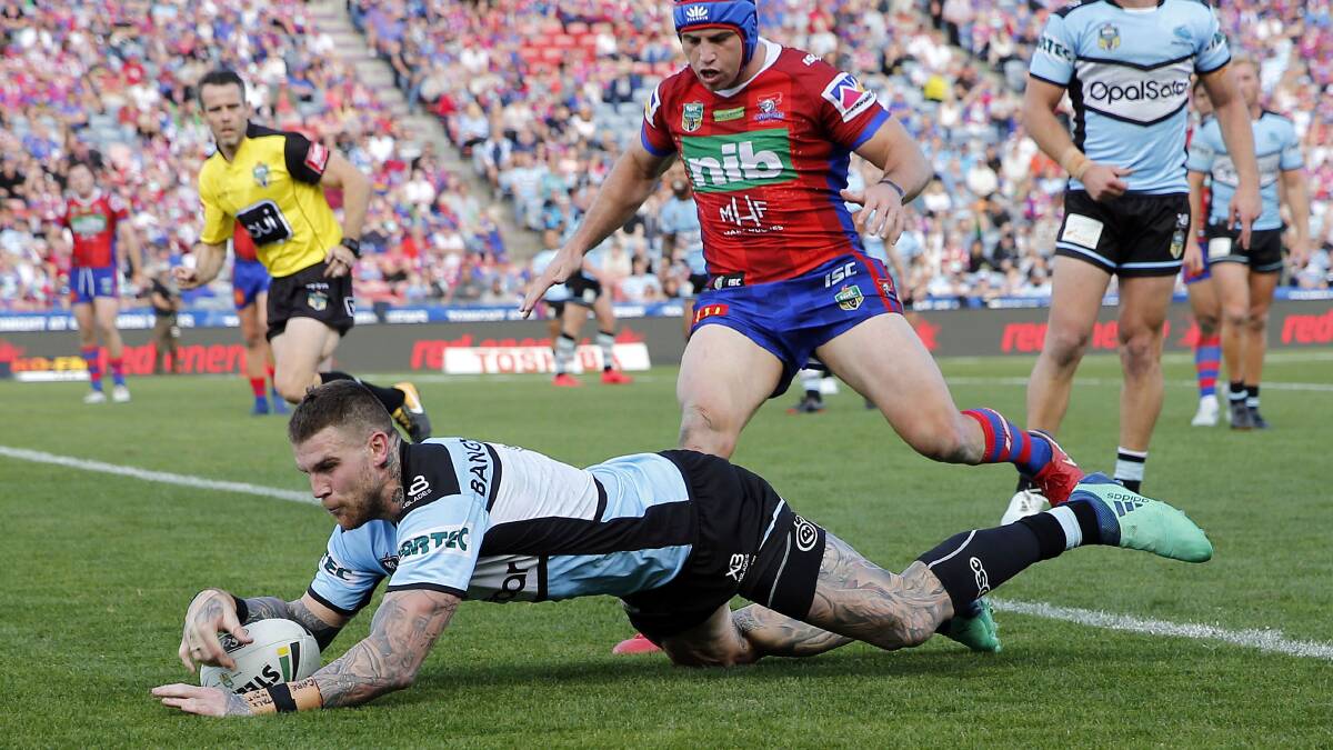 Big day out: Cronulla fullback Josh Dugan crosses for a try just before half-time. Picture: AAP Images