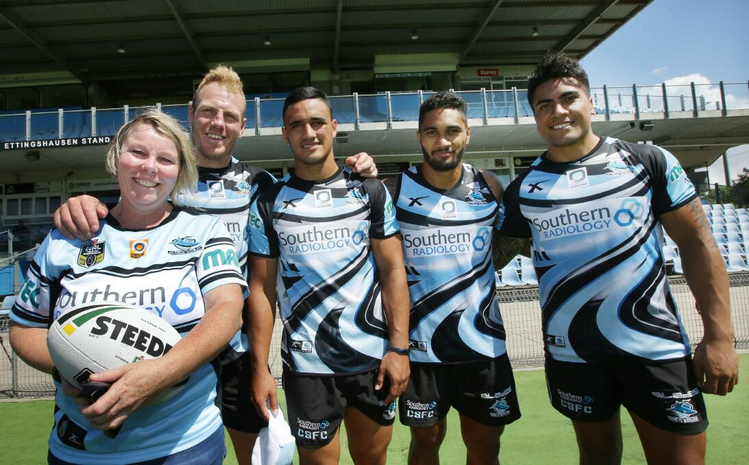 Milestone: Cronulla's 10,000th member Yvette Parker celebrated by meeting with Sharks players Luke Lewis, Valentine Holmes, Ricky Leutele and Sosaia Feki at Shark Park on Monday. Picture: John Veage