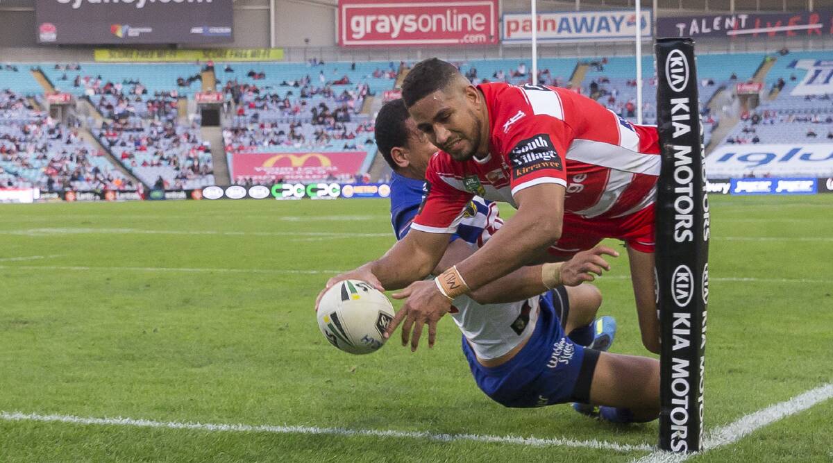 Close shave: Dragons winger Nene Macdonald reaches out to score in the corner as St George Illawarra downed Cantebury on Monday. Picture: Craig Golding/AAP Image