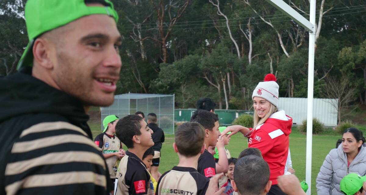 Star effort: Dragons five-eighth Corey Norman interacts with young Kogarah Cougars players alongside Dragons WNRL star Kezie Apps. Picture: Chris Lane