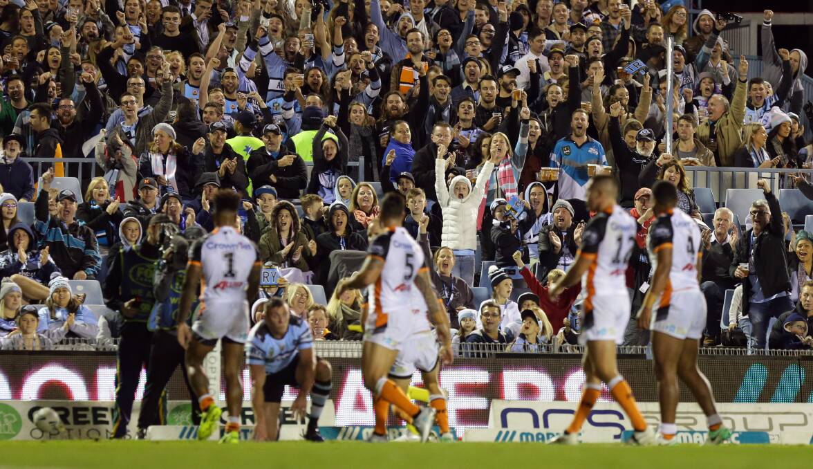 Four-pointer: Kurt Capewell scores his first NRL try while the Sharks fans celebrate. Picture: Chris Lane