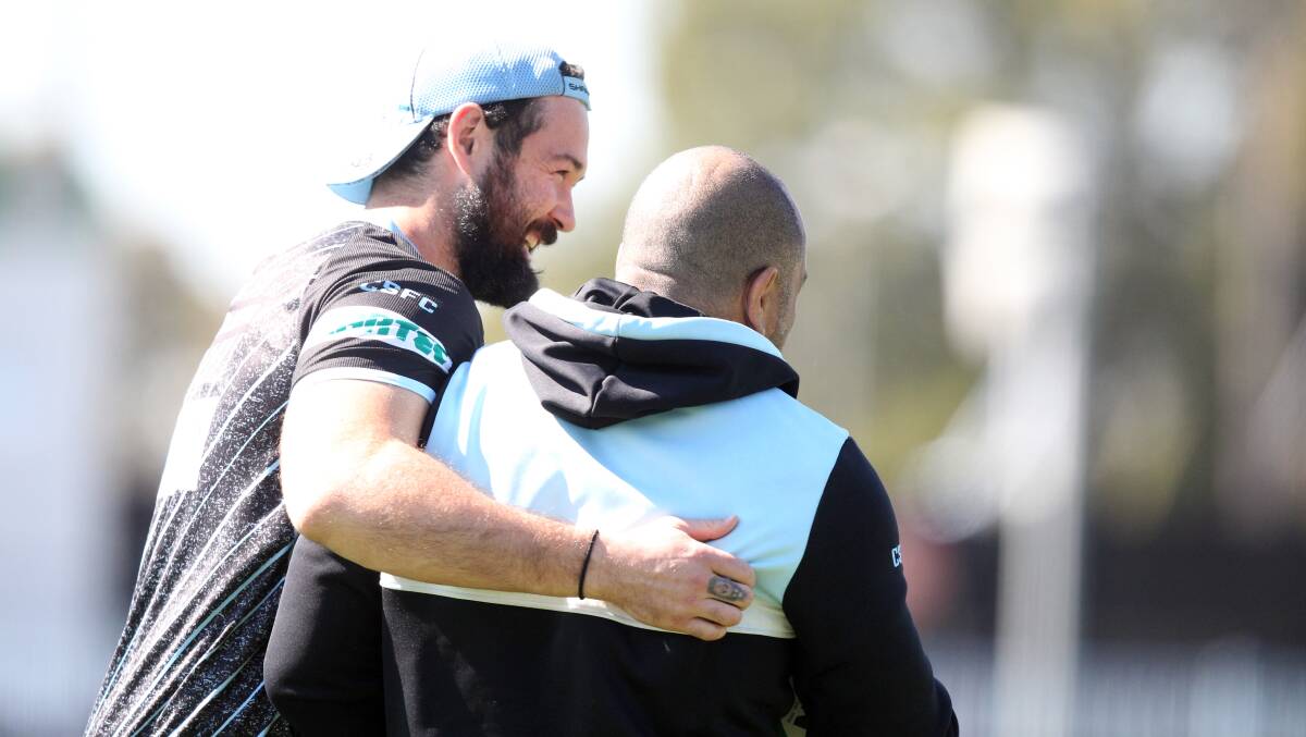 Aaron Woods shares a laugh with Jim Dymock at Sharks training on Tuesday. Picture: Chris Lane
