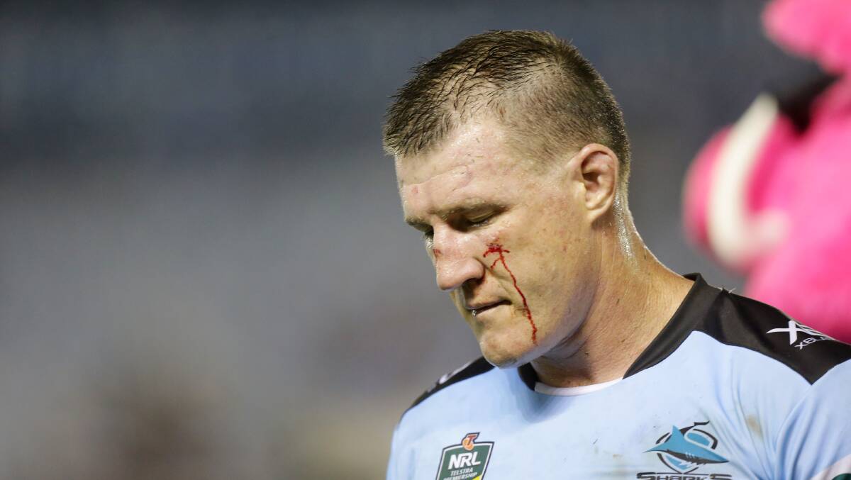 Hurting: Sharks captain Paul Gallen is cut against the Dragons. Picture: Chris Lane