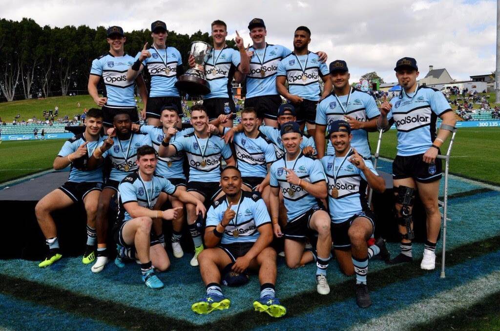 Champions: Cronulla's Jersey Flegg Cup-winning team celebrate their triumph on Sunday. Picture: Grant Trouville/NRL Photos