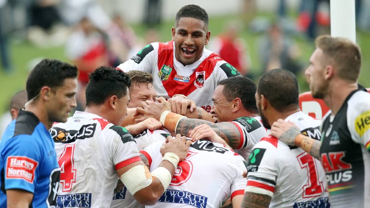All together: Dragons winger Nene Macdonald helps lead the celebrations after a Jack de Belin try against Penrith in round one. Picture: Chris Lane