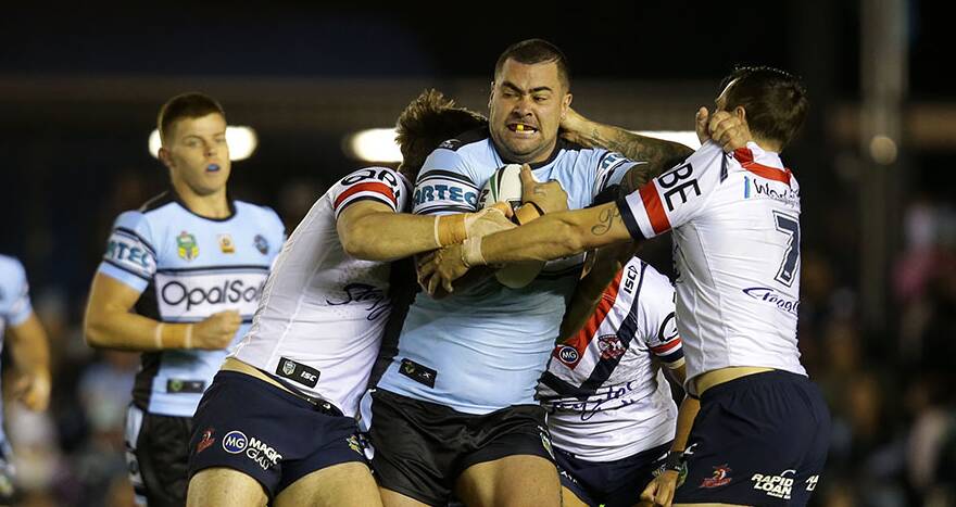 No way through: Sharks prop Andrew Fifita is stopped by Roosters defenders on Saturday night. Picture: John Veage