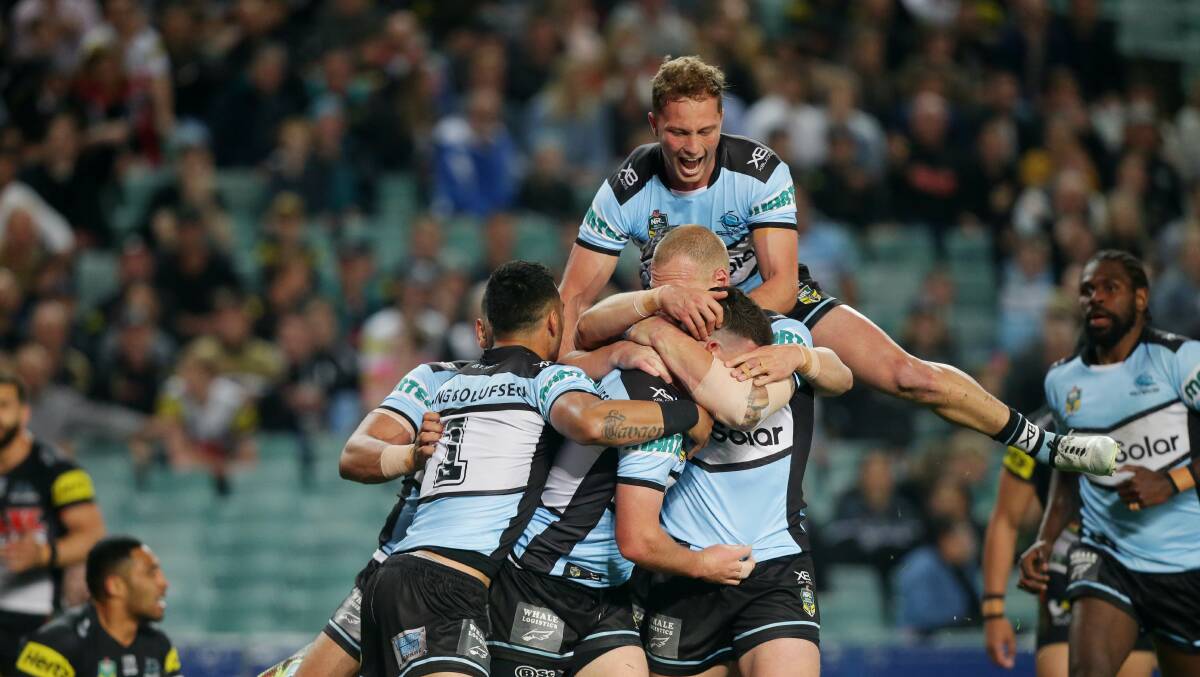 Celebration time: Chad Townsend is congratulated by his Cronulla teammates after scoring the opening try against Penrith. Picture: Chris Lane
