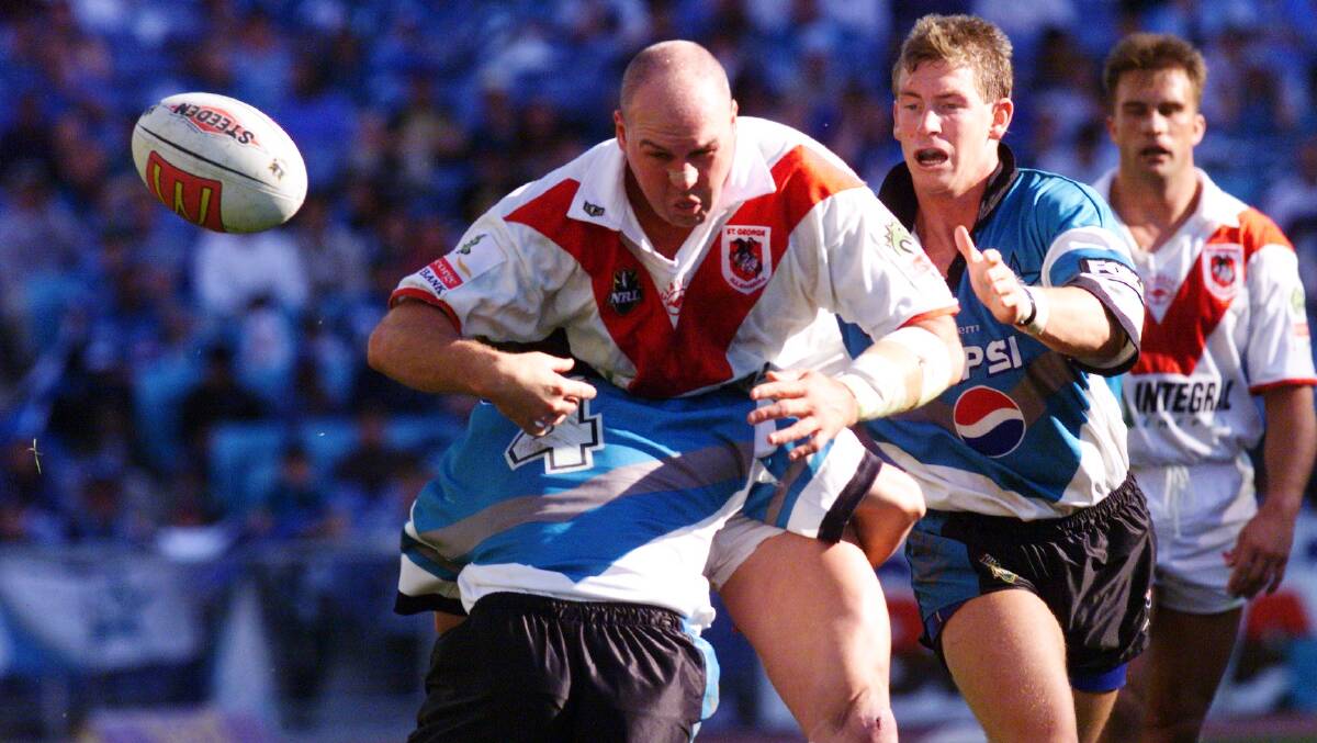 Battle: Paul McGregor playing for the Dragons against Cronulla in 1999. Picture: Ken Robertson