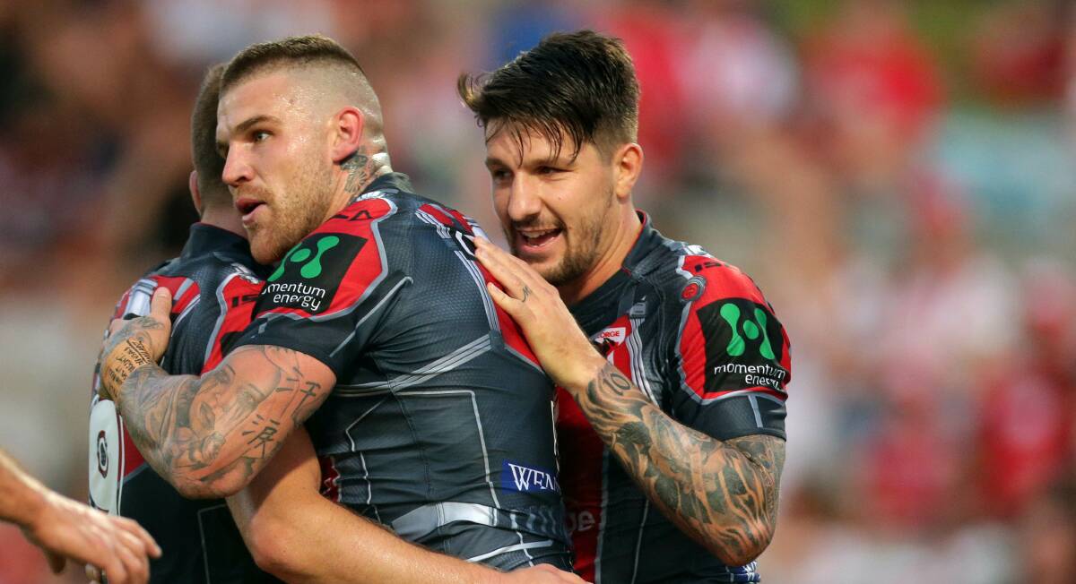 Happier times: Dragons captain Gareth Widdop celebrates a try with Josh Dugan against the Warriors. Picture: Chris Lane