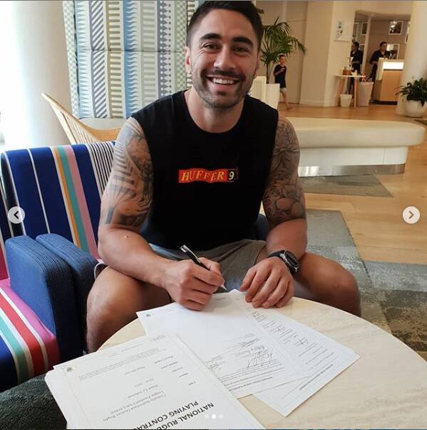Shaun Johnson signs his contract with Cronulla. Picture: Instagram