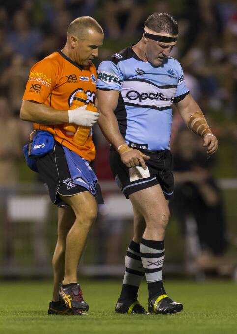 Worry: Sharks captain Paul Gallen is helped from the ground after suffering a knee injury against the Dragons on Friday night. Picture: AAP Image