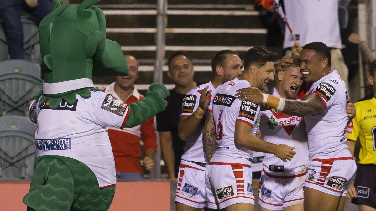 Happy Dragons: St George Illawarra players celebrate Matt Dufty's try against Cronulla at WIN Stadium on Friday night. Picture: Craig Golding/AAP Image