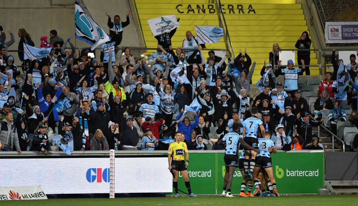 Winners: Cronulla players celebrate Valentine Holmes' second try in front of Sharks fans in Canberra on Sunday. Picture: AAP Images