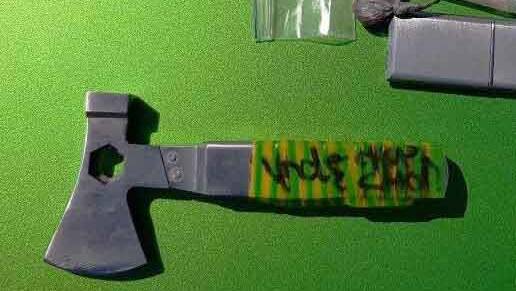  SHARP: An axe was among the contraband seized. Corrections NSW said five people were charged.

